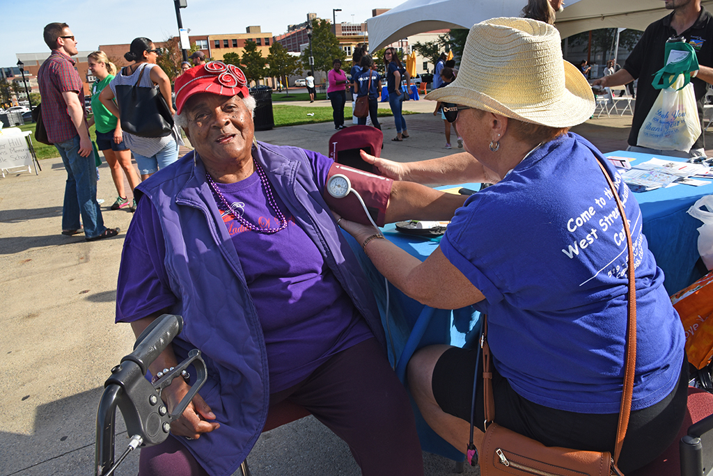 Community event checking blood pressure