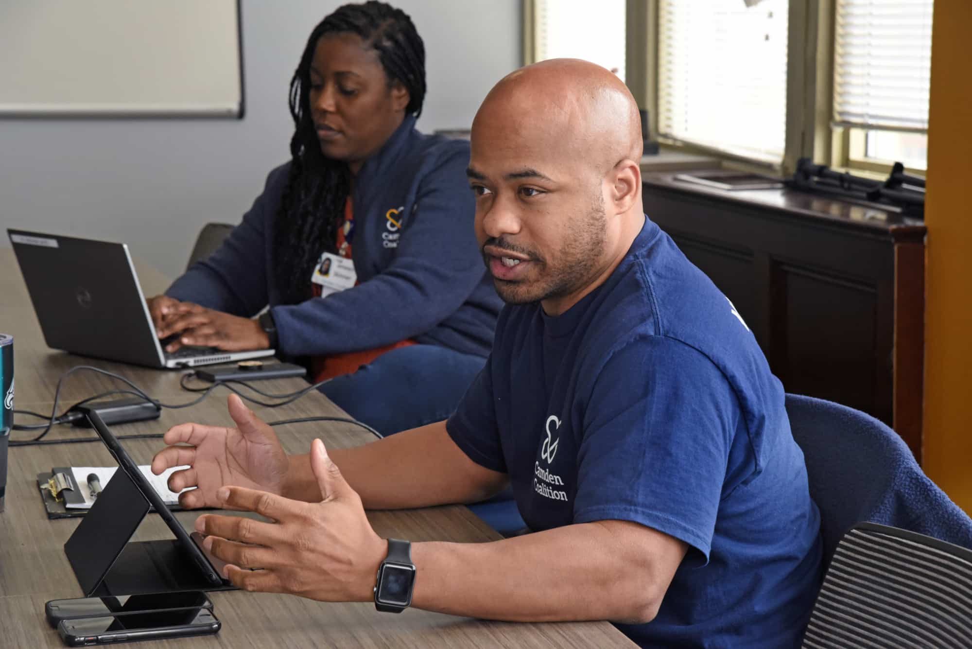 Camden Coalition staff member explaining something while sitting at a conference table
